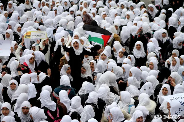 Palestinians female students shout slogans as she and others take part in a protest organized by the Islamic Hamas movement in Gaza city, on February 29, 2012, to show solidarity with Palestinians protesting last week at...