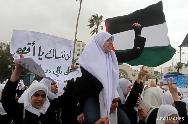 Palestinians female students shout slogans as she and others take part in a protest organized by the Islamic Hamas movement in Gaza city, on February 29, 2012, to show solidarity with Palestinians protesting last week at...