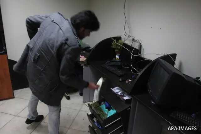 Staff members of a local private television station "Watan", look at the damage caused after Israeli troops raided this and another Palestinian television station in the West Bank city of Ramallah overnight, seizing comp...