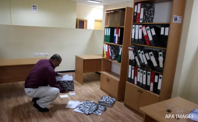 Staff members of a local private television station "Watan", look at the damage caused after Israeli troops raided this and another Palestinian television station in the West Bank city of Ramallah overnight, seizing comp...