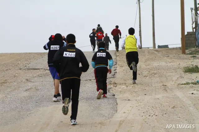 Participants compete in the UN-sponsored Gaza marathon in Gaza City on March 1, 2012. Thousands of runners braved temperatures hovering just above zero degrees centigrade to take part in the impoverished Palestinian terr...