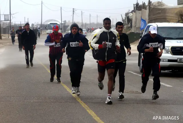 Participants compete in the UN-sponsored Gaza marathon in Gaza City on March 1, 2012. Thousands of runners braved temperatures hovering just above zero degrees centigrade to take part in the impoverished Palestinian terr...