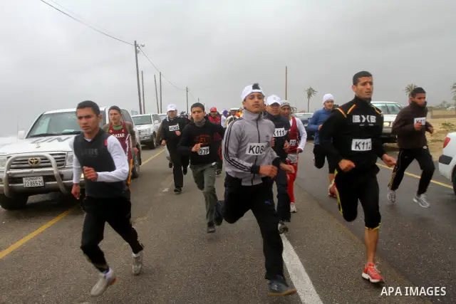 Participants compete in the UN-sponsored Gaza marathon in Gaza City on March 1, 2012. Thousands of runners braved temperatures hovering just above zero degrees centigrade to take part in the impoverished Palestinian terr...