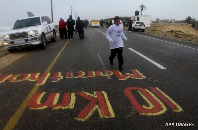 Participants compete in the UN-sponsored Gaza marathon in Gaza City on March 1, 2012. Thousands of runners braved temperatures hovering just above zero degrees centigrade to take part in the impoverished Palestinian terr...
