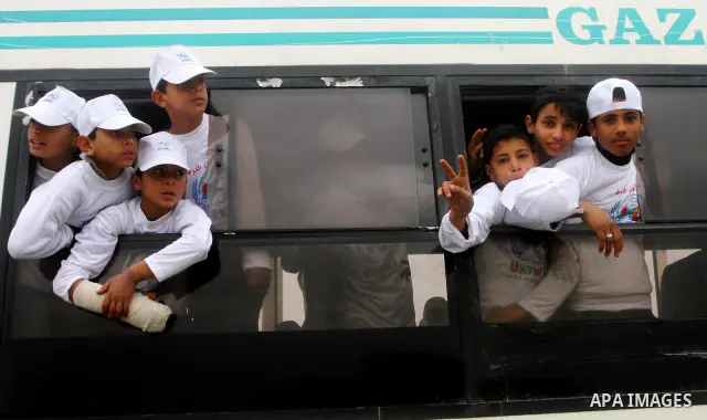 Palestinian children watch a 10 km race, as part of the second annual Gaza Marathon, organized by the United Nations Relief and Works Agency (UNRWA) in Gaza City March 1, 2012. According to UNWRA, nearly 2,000 runners, P...