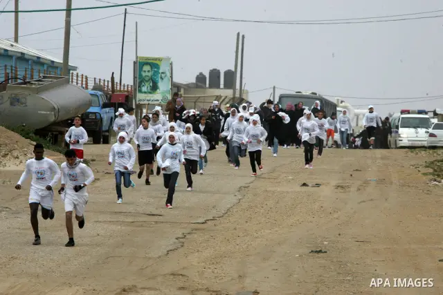 Participants warm up before competing in the UN-sponsored Gaza marathon in Rafah town, in the southern Gaza Strip on March 1, 2012. Thousands of runners braved temperatures hovering just above zero degrees centigrade to...