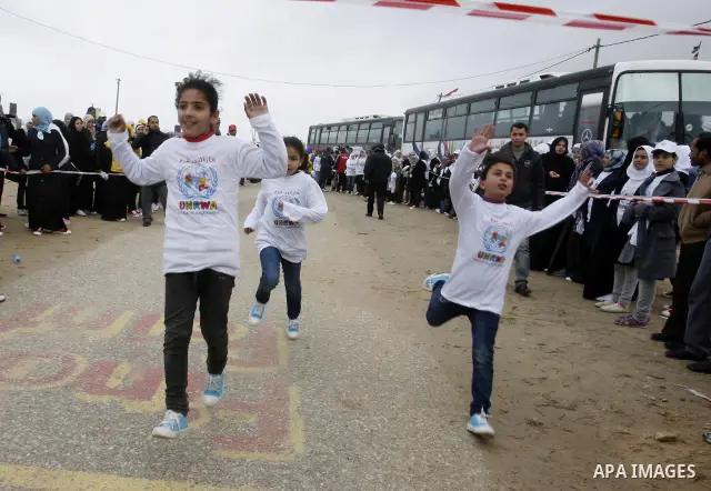 Participants warm up before competing in the UN-sponsored Gaza marathon in Rafah town, in the southern Gaza Strip on March 1, 2012. Thousands of runners braved temperatures hovering just above zero degrees centigrade to...