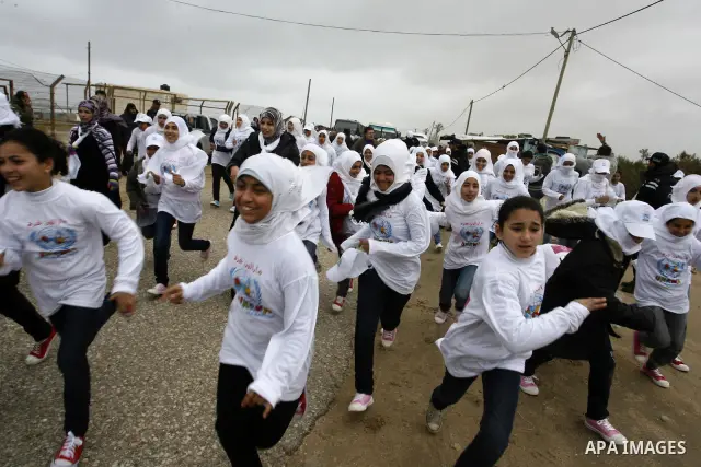 Participants warm up before competing in the UN-sponsored Gaza marathon in Rafah town, in the southern Gaza Strip on March 1, 2012. Thousands of runners braved temperatures hovering just above zero degrees centigrade to...