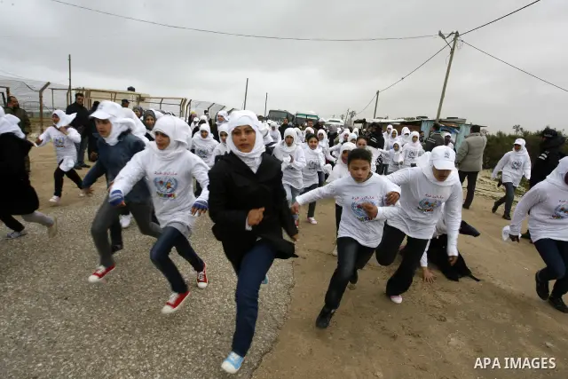 Participants warm up before competing in the UN-sponsored Gaza marathon in Rafah town, in the southern Gaza Strip on March 1, 2012. Thousands of runners braved temperatures hovering just above zero degrees centigrade to...