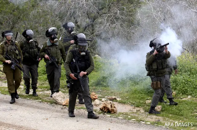 Israeli soldiers fire tear gas canisters towards Palestinian protesters during a demonstration against the expropriation of Palestinian land by Israel in the village of Kfar Qaddum, near the West Bank city of Nablus, on...
