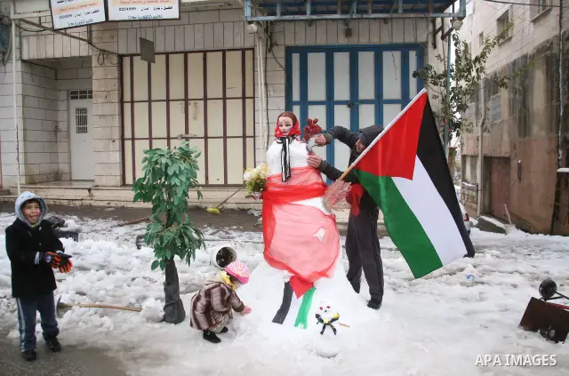 Palestinians build a snowman in the West Bank city of Hebron, on 02 March 2012. A rare snow storm has hit the higher elevations in Israel and the West Bank, including Jerusalem, after four days of pouring rain and high w...