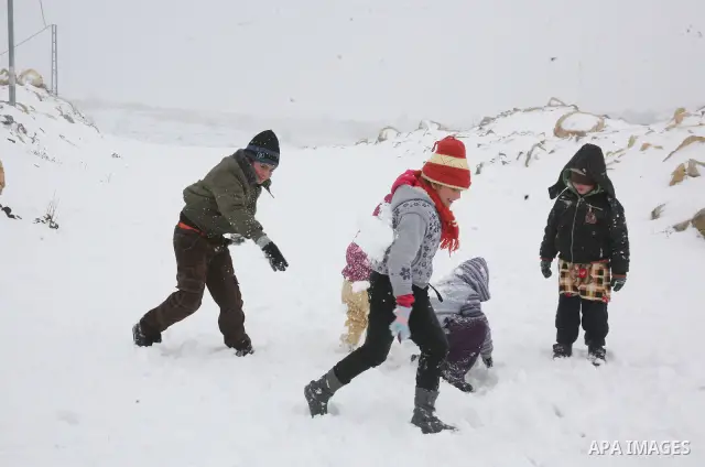 Palestinian boys play with snow in the West Bank city of Hebron as wintry weather swept through the region on March 2, 2012. Photo by Mamoun Wazwaz