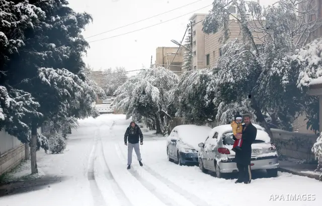 Palestinians walks during a snow storm in the West Bank city of Hebron as wintry weather swept through the region on March 2, 2012. Photo by Mamoun Wazwaz
