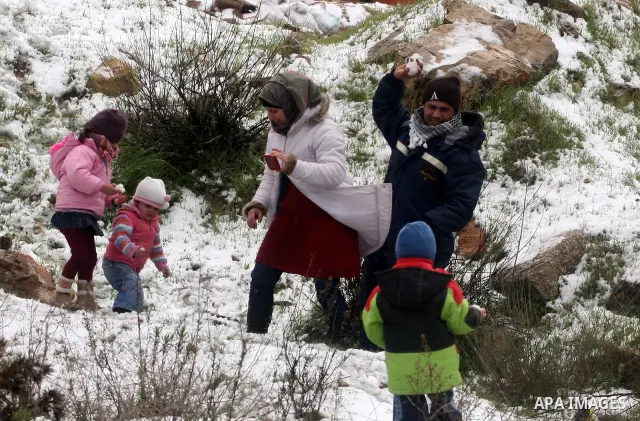 Palestinians throw snowballs in the West Bank city of Ramallah as wintry weather swept through the region on March 2, 2012. Photo by Issam Rimawi