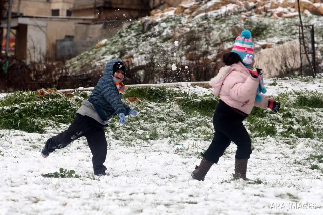 Palestinians throw snowballs in the West Bank city of Ramallah as wintry weather swept through the region on March 2, 2012. Photo by Issam Rimawi