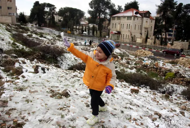 Palestinians throw snowballs in the West Bank city of Ramallah as wintry weather swept through the region on March 2, 2012. Photo by Issam Rimawi
