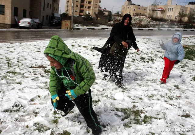 Palestinians throw snowballs in the West Bank city of Ramallah as wintry weather swept through the region on March 2, 2012. Photo by Issam Rimawi