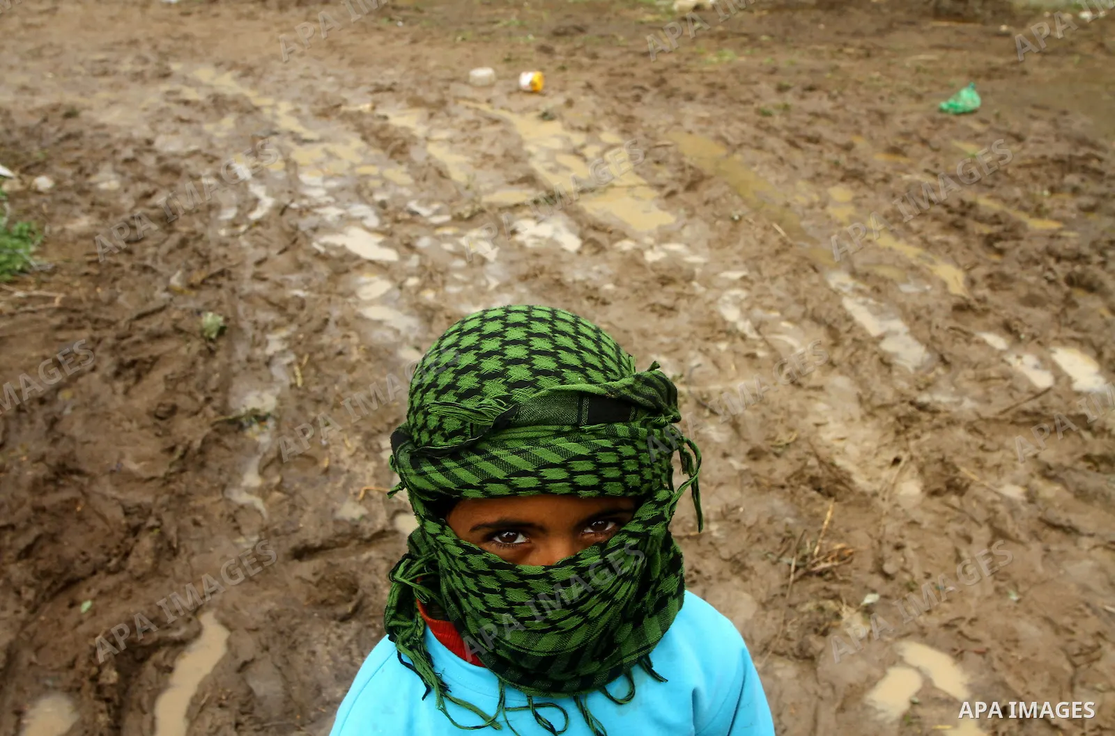 Palestinian Bedouin children walk through muddy waters after heavy rains which flooded the Al Moghraka area in the central Gaza Strip, 04 March 2012. Photo by Ashraf Amra