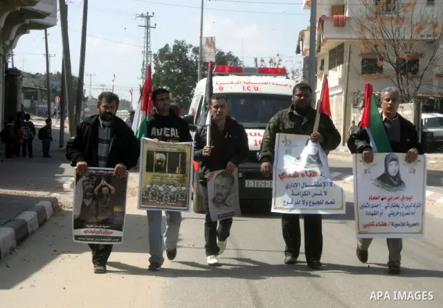 Palestinian Protestors hold a picture of Palestinian prisoner Hana'a Shalabi, in Rafah City, southern Gaza Strip, on Mar. 05, 2012. Photo by Abed Rahim Khatib
