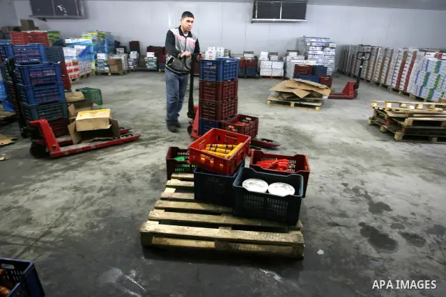 Palestinian workers employed in the warehouses of refrigerators for goods in Nusseirat refugee camp in central Gaza Strip on March 5, 2012. While the owners of freezers traders suffer from power cuts and lack of diesel f...