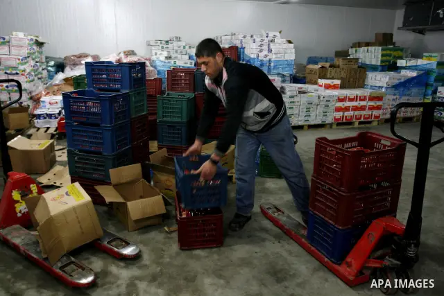 Palestinian workers employed in the warehouses of refrigerators for goods in Nusseirat refugee camp in central Gaza Strip on March 5, 2012. While the owners of freezers traders suffer from power cuts and lack of diesel f...