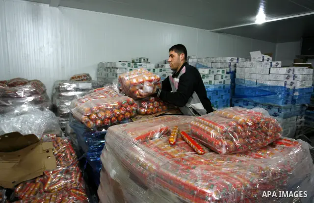 Palestinian workers employed in the warehouses of refrigerators for goods in Nusseirat refugee camp in central Gaza Strip on March 5, 2012. While the owners of freezers traders suffer from power cuts and lack of diesel f...