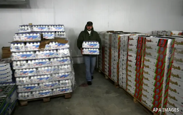 Palestinian workers employed in the warehouses of refrigerators for goods in Nusseirat refugee camp in central Gaza Strip on March 5, 2012. While the owners of freezers traders suffer from power cuts and lack of diesel f...