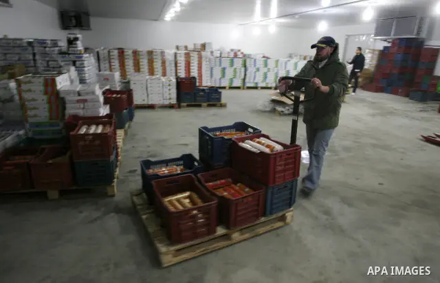 Palestinian workers employed in the warehouses of refrigerators for goods in Nusseirat refugee camp in central Gaza Strip on March 5, 2012. While the owners of freezers traders suffer from power cuts and lack of diesel f...