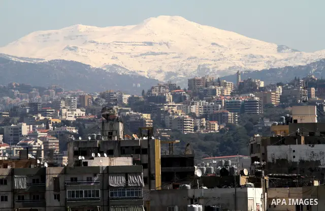 Snow covers Beirut mountains (background) in Lebanon, after a heavy snowstorm, March 5, 2012. Photo by Mohammed Asad