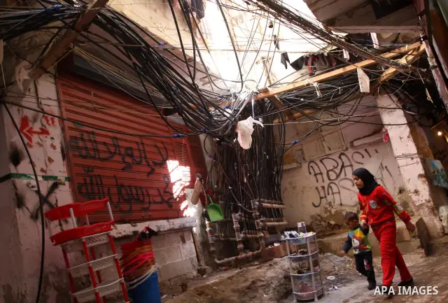 Palestinians walk in alley in one of the most poor regions at Burj al-Barajneh Palestinian refugee camp in Beirut, in Lebanon, March 5, 2012. About 25,000 person live in this poor refugee camp who face hard and difficult...