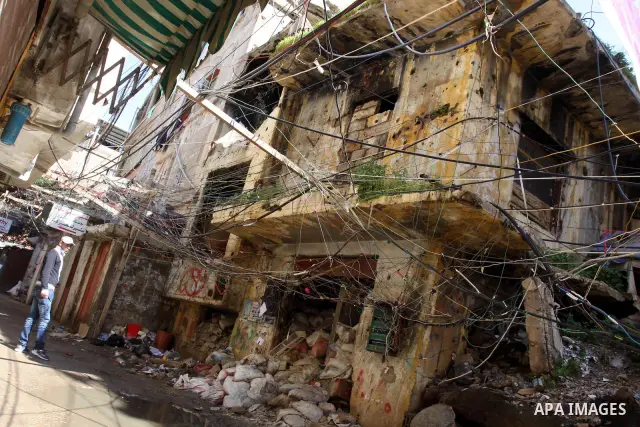 Palestinians walk in alley in one of the most poor regions at Burj al-Barajneh Palestinian refugee camp in Beirut, in Lebanon, March 5, 2012. About 25,000 person live in this poor refugee camp who face hard and difficult...