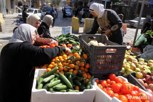 Palestinians buy vegetables and fruit in one of the most poor regions at Burj al-Barajneh Palestinian refugee camp in Beirut, in Lebanon, March 5, 2012. About 25,000 person live in this poor refugee camp who face hard an...