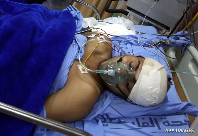 Palestinian Mohammed Abu-Awad, 19, injured by Israeli soldiers at a checkpoint near Ramallah earlier, receives treatment in hospital in the West Bank city of Ramallah, Monday, March 5, 2012. A young Palestinian man throw...