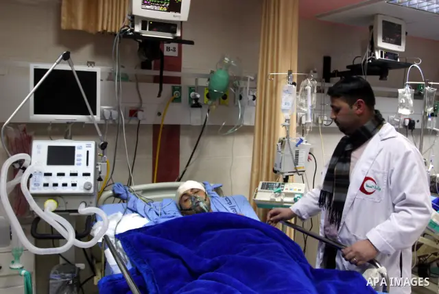 Palestinian Mohammed Abu-Awad, 19, injured by Israeli soldiers at a checkpoint near Ramallah earlier, receives treatment in hospital in the West Bank city of Ramallah, Monday, March 5, 2012. A young Palestinian man throw...