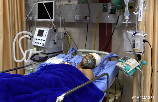 Palestinian Mohammed Abu-Awad, 19, injured by Israeli soldiers at a checkpoint near Ramallah earlier, receives treatment in hospital in the West Bank city of Ramallah, Monday, March 5, 2012. A young Palestinian man throw...