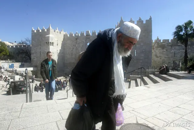 Palestinians walk outside Damascus Gate leading into the old city of Jerusalem on March 6, 2012. Photo by Mahfouz Abu Turk