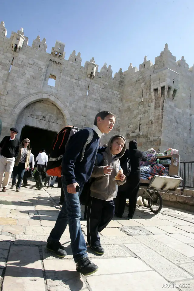A Palestinian students walk outside Damascus Gate leading into the old city of Jerusalem on March 6, 2012. Photo by Mahfouz Abu Turk