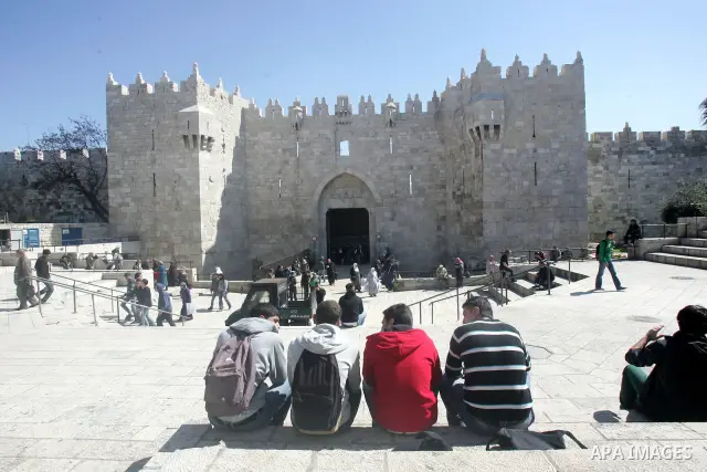 Palestinians walk outside Damascus Gate leading into the old city of Jerusalem on March 6, 2012. Photo by Mahfouz Abu Turk