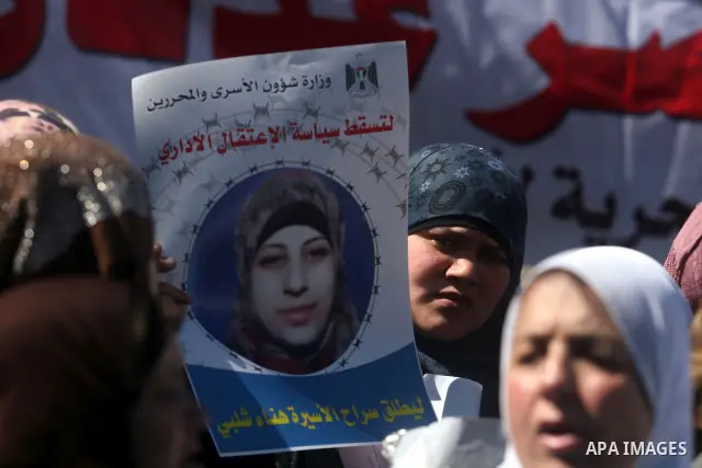 Families of Palestinians prisoners, held in Israeli jails, holding the pictures, of Hana Shalabi 30, from the militant Islamic Jehad movement in front of the International Committee of the Red Cross, (ICRC) offices in th...