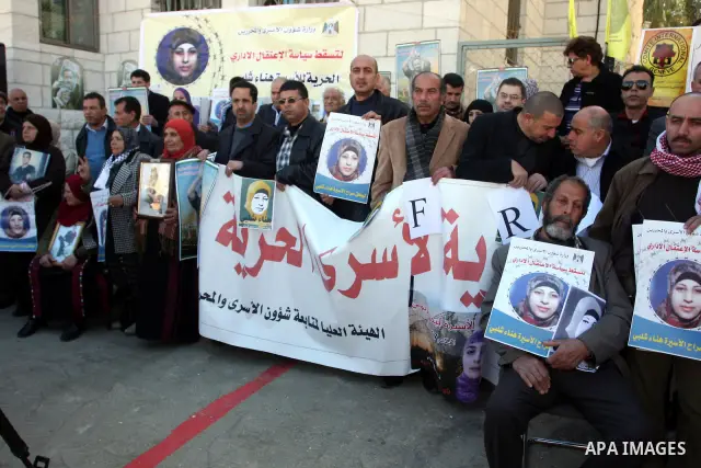 Yaheah Shalabi 67, the father Palestinian prisoners being held in Israeli jails hold the pictures of his daughter Hana Shalabi 30, from the militant Islamic Jehad movement in front of the International Committee of the R...