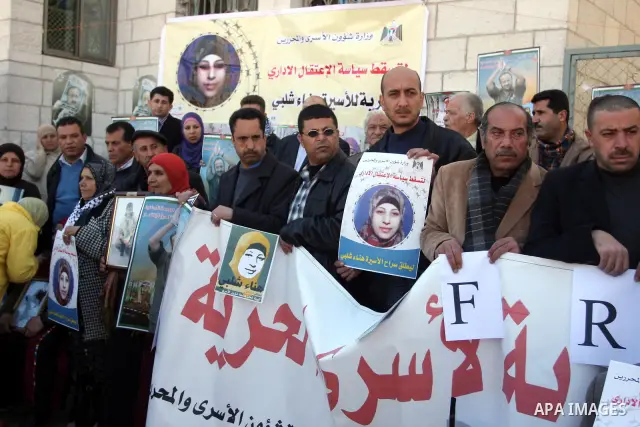 Families of Palestinians prisoners, held in Israeli jails, holding the pictures, of Hana Shalabi 30, from the militant Islamic Jehad movement in front of the International Committee of the Red Cross, (ICRC) offices in th...