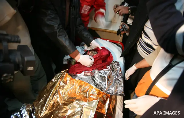 Palestinian medics bring the bodies of two children into a morgue in the West Bank city of Hebron, 06 March 2012. The Palestinian children apparently were killed while handling munitions which they collected from an Isra...
