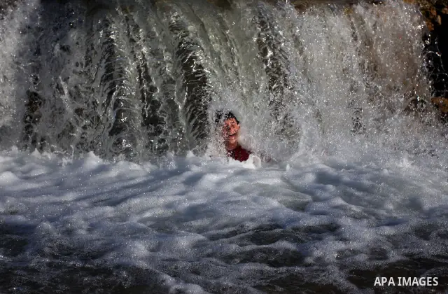 Palestinian children Swimming in the waters of "Wadi Ain Qeigna" in West Bank near Ramallah City, 6 March 2012. Photo by Issam Rimawi