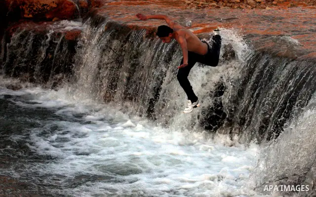 Palestinian children Swimming in the waters of "Wadi Ain Qeigna" in West Bank near Ramallah City, 6 March 2012. Photo by Issam Rimawi
