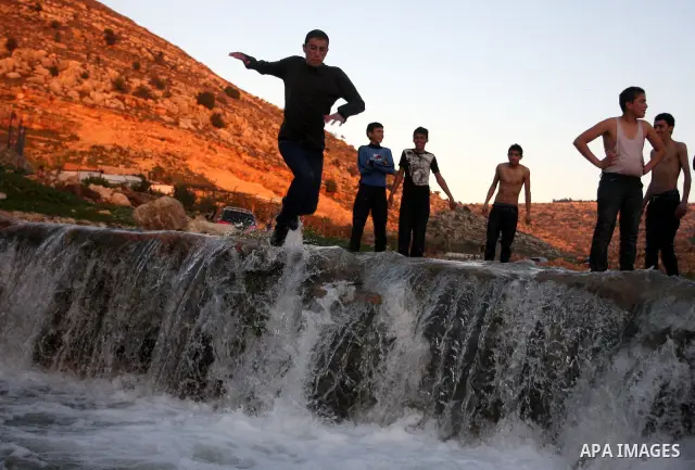 Palestinian children Swimming in the waters of "Wadi Ain Qeigna" in West Bank near Ramallah City, 6 March 2012. Photo by Issam Rimawi