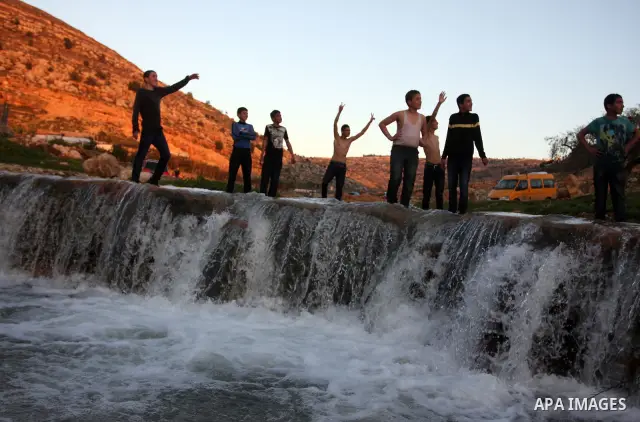 Palestinian children Swimming in the waters of "Wadi Ain Qeigna" in West Bank near Ramallah City, 6 March 2012. Photo by Issam Rimawi