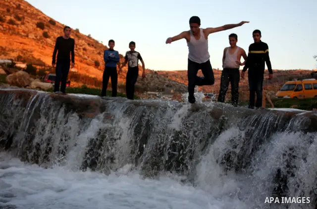 Palestinian children Swimming in the waters of "Wadi Ain Qeigna" in West Bank near Ramallah City, 6 March 2012. Photo by Issam Rimawi