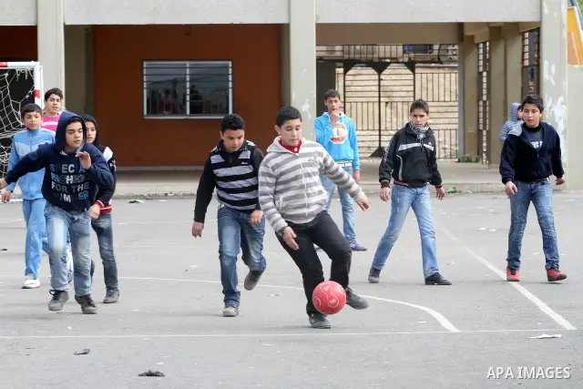 Palestinian children play the foot ball in street at regions Nahr al-Bared Palestinian refugee camp in Beirut, in Lebanon, March 6, 2012. About 25,000 person live in this poor refugee camp who face hard and difficult lif...