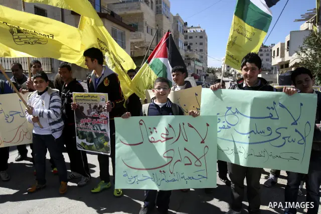 Palestinians take part in a protest in solidarity with Hana Shalabi, a Palestinian prisoner jailed in Israel and who has been on hunger strike for 21 days, in the West Bank in Nablus, Wednesday, March 7, 2012. Palestinia...