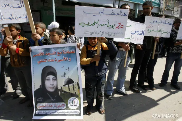 Palestinians demonstrate in solidarity with Hana'a Shalabi during a protest in Rafah, southern Gaza Strip on March 7, 2012. Shalabi, released by Israel in a prisoner swap last year but re-arrested earlier this month and...